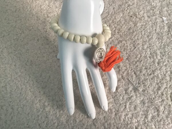 Sacral Chakra White Bead Orange Tassel Bracelet - Image 2